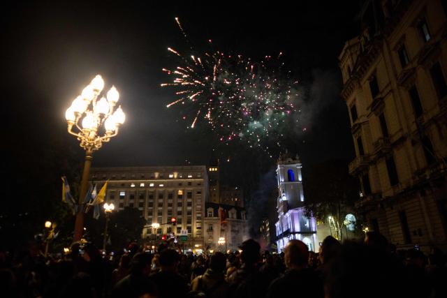 Fireworkfs explode as fans of Carlos Alberto "Indio" Solari, the iconic Argentine rock musician and former lead singer of Patricio Rey y sus Redonditos de Ricota, gather at Plaza de Mayo after the singer died in Parque Leloir, Buenos Aires Province, at the age of 77, on June 5, 2026. (Photo by TOMAS CUESTA / AFP)