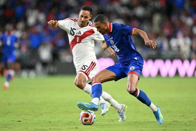 Peru's defender #15 Renzo Garces and Haiti's forward #18 Wilson Isidor vie for the ball during the international friendly football match between Haiti and Peru at Nu Stadium in Miami, Florida on June 5, 2026. (Photo by CHANDAN KHANNA / AFP)