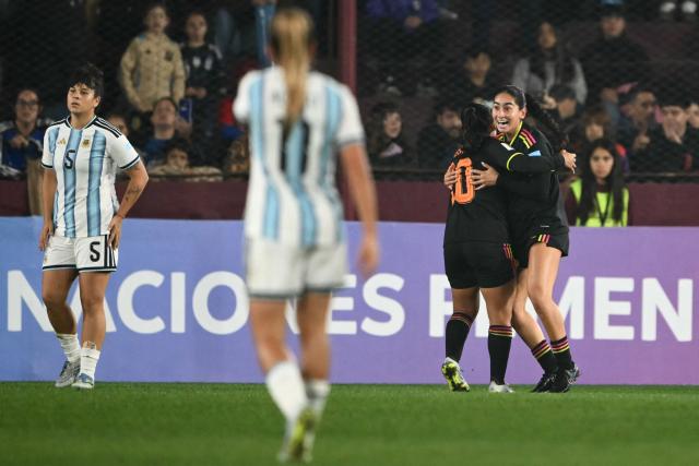 Peru's midfielder #11 Cherrie Cox celebrates with her teammate Peru's midfielder #10 Sandra Arevalo after scoring an equalising goal during the CONMEBOL Nations League Women football match between Argentina and Peru at the Florencio Sola stadium in Buenos Aires on June 5, 2026. (Photo by Luis ROBAYO / AFP)