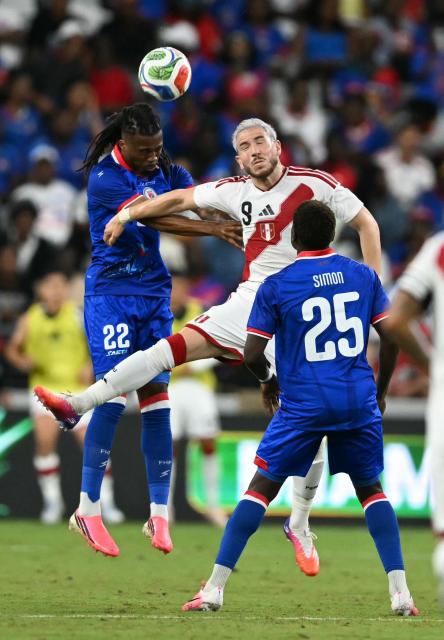 Haiti's defender #22 Jean-Kevin Duverne and Peru's forward #09 Adrian Ugarriza vie for the ball as Haiti's midfielder #25 Dominique Simon looks on during the international friendly football match between Haiti and Peru at Nu Stadium in Miami, Florida on June 5, 2026. (Photo by CHANDAN KHANNA / AFP)