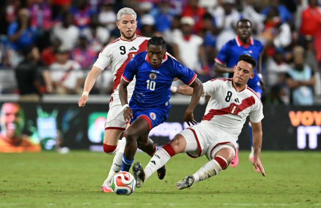 Haiti's midfielder #10 Jean-Ricner Bellegarde controls the ball away from Peru's defender #08 Erick Noriega and Peru's forward #09 Adrian Ugarriza during the international friendly football match between Haiti and Peru at Nu Stadium in Miami, Florida on June 5, 2026. (Photo by CHANDAN KHANNA / AFP)