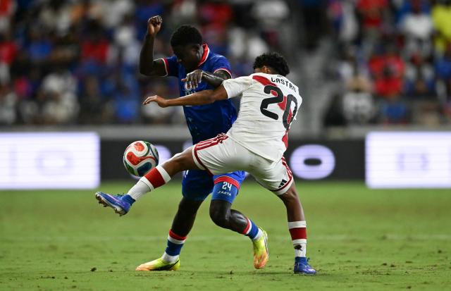 Haiti's defender #24 Wilguens Paugain and Peru's forward #20 Maxloren Castro vie for the ball during the international friendly football match between Haiti and Peru at Nu Stadium in Miami, Florida on June 5, 2026. (Photo by CHANDAN KHANNA / AFP)