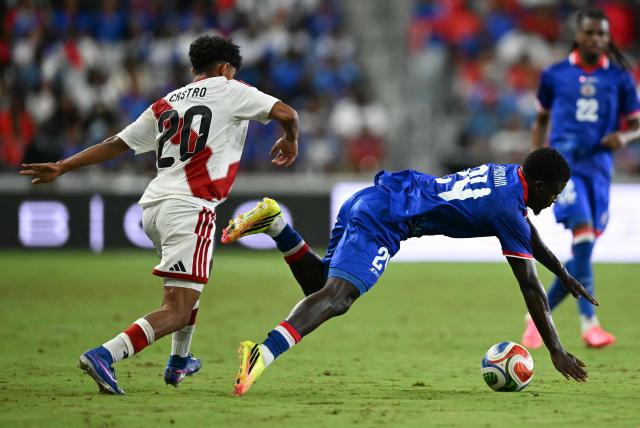 Peru's forward #20 Maxloren Castro and Haiti's defender #24 Wilguens Paugain vie for the ball during the international friendly football match between Haiti and Peru at Nu Stadium in Miami, Florida on June 5, 2026. (Photo by CHANDAN KHANNA / AFP)