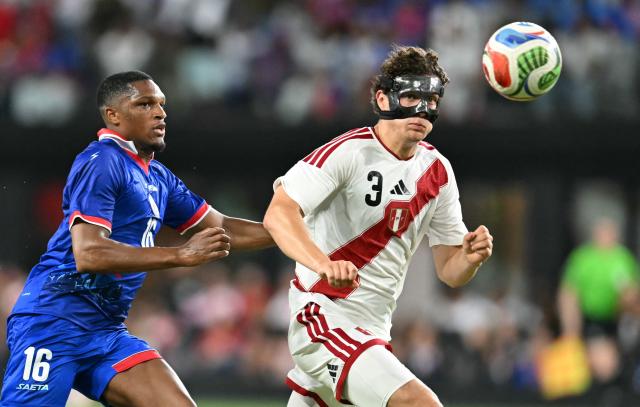 Peru's defender #03 Fabio Gruber and Haiti's forward #16 Lenny Joseph run for the ball during the international friendly football match between Haiti and Peru at Nu Stadium in Miami, Florida on June 5, 2026. (Photo by CHANDAN KHANNA / AFP)