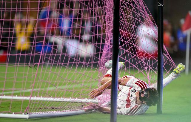 Peru's defender #03 Fabio Gruber lands in the net after saving a goal during the international friendly football match between Haiti and Peru at Nu Stadium in Miami, Florida on June 5, 2026. (Photo by CHANDAN KHANNA / AFP)