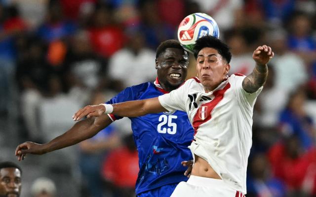 Haiti's midfielder #25 Dominique Simon and Peru's midfielder #06 Jesus Pretell head the ball during the international friendly football match between Haiti and Peru at Nu Stadium in Miami, Florida on June 5, 2026. (Photo by CHANDAN KHANNA / AFP)
