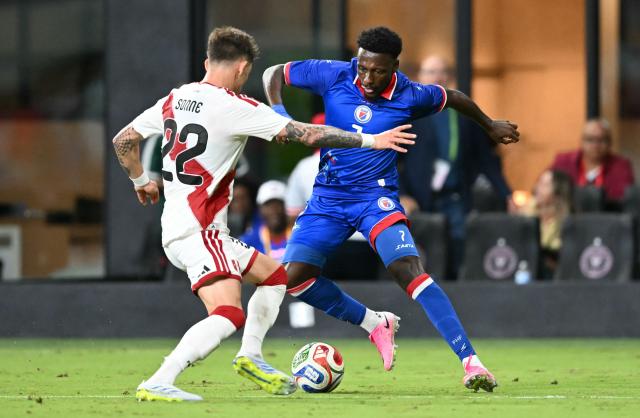 Peru's defender #22 Oliver Sonne and Haiti's forward #07 Derrick Etienne vie for the ball during the international friendly football match between Haiti and Peru at Nu Stadium in Miami, Florida on June 5, 2026. (Photo by CHANDAN KHANNA / AFP)