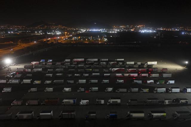Aerial view of trucks loaded with election material at Peru's National Office of Electoral Processes (ONPE) in Lima on June 5, 2026. Right-wing candidate Keiko Fujimori and leftist Roberto Sanchez will face off in Peru's presidential runoff on June 7, 2026. (Photo by ERNESTO BENAVIDES / AFP)