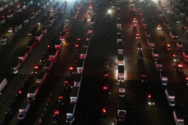 Aerial view of trucks loaded with election material at Peru's National Office of Electoral Processes (ONPE) in Lima on June 5, 2026. Right-wing candidate Keiko Fujimori and leftist Roberto Sanchez will face off in Peru's presidential runoff on June 7, 2026. (Photo by ERNESTO BENAVIDES / AFP)