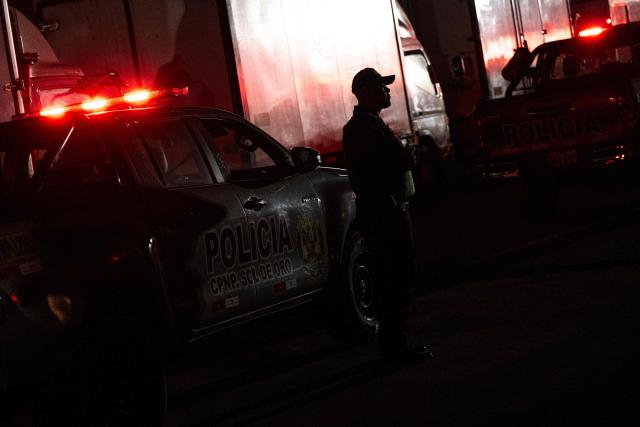 A police officers custodies trucks loaded with election material at Peru's National Office of Electoral Processes (ONPE) in Lima on June 5, 2026. Right-wing candidate Keiko Fujimori and leftist Roberto Sanchez will face off in Peru's presidential runoff on June 7, 2026. (Photo by ERNESTO BENAVIDES / AFP)