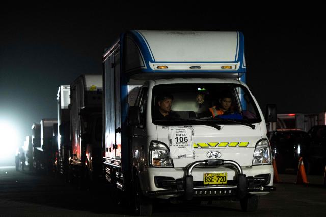 Trucks loaded with electoral material are pictured at Peru's National Office of Electoral Processes (ONPE) in Lima on June 5, 2026. Right-wing candidate Keiko Fujimori and leftist Roberto Sanchez will face off in Peru's presidential runoff on June 7, 2026. (Photo by ERNESTO BENAVIDES / AFP)