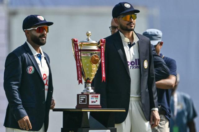 India's captain Shubman Gill (R) and his Afghanistani counterpart Hashmatullah Shahidi pose with the winning trophy before the start of the first day of the only Test cricket match between India and Afghanistan at the Maharaja Yadavindra Singh International Cricket Stadium on the outskirts of Chandigarh on June 6, 2026. (Photo by Shammi MEHRA / AFP)