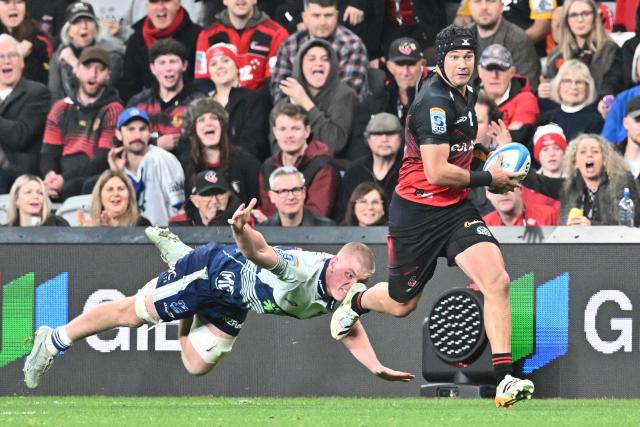 Crusaders' David Havili (R) runs with the ball during the Super Rugby Pacific Quarter final match between the Canterbury Crusaders and Blues at One New Zealand Stadium in Christchurch on June 6, 2026. (Photo by Sanka VIDANAGAMA / AFP)