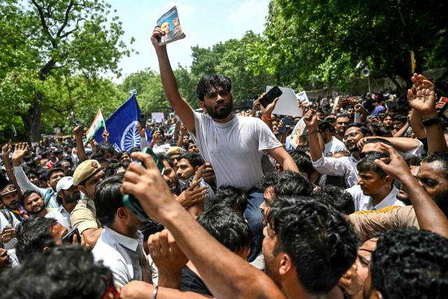Cockroach Janta Party (CJP) founder Abhijeet Dipke (C) takes part in a protest over alleged irregularities in the country's major examinations, in New Delhi on June 6, 2026. Hundreds of young students gathered in New Delhi on June 6 for the first street protest by the satirical "Cockroach People's Party" over alleged irregularities in major examinations held in the country recently. (Photo by Arun SANKAR / AFP)