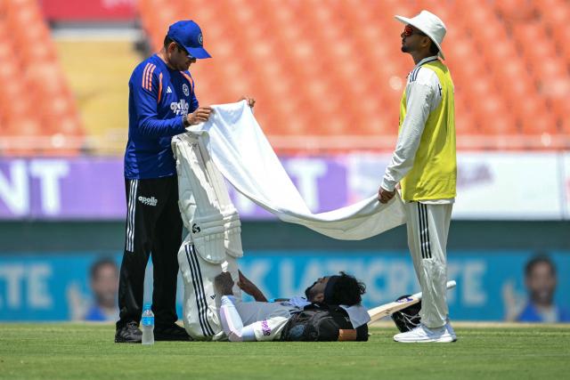India's KL Rahul (C) takes shelter under a towel from the sun during a break in the first day of the only Test cricket match between India and Afghanistan at the Maharaja Yadavindra Singh International Cricket Stadium on the outskirts of Chandigarh on June 6, 2026. (Photo by Shammi MEHRA / AFP)