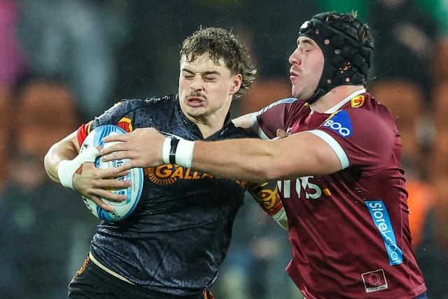 Chiefs' Isaac Hutchinson (L) gets tackled by Reds’ Joe Brial (R) during the Super Rugby qualifying final match between the Chiefs and Queensland Reds at FMG Stadium in Hamilton on June 6, 2026. (Photo by DJ MILLS / AFP)