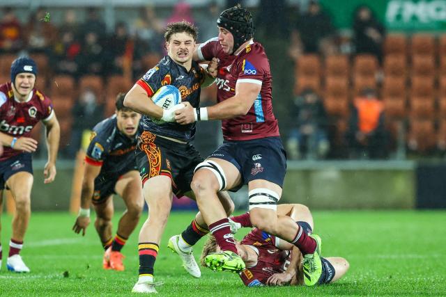 Chiefs' Isaac Hutchinson (L) gets tackled by Reds’ Joe Brial (R) during the Super Rugby qualifying final match between the Chiefs and Queensland Reds at FMG Stadium in Hamilton on June 6, 2026. (Photo by DJ MILLS / AFP)