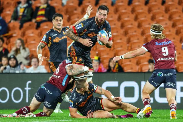 Chiefs' Josh Lord is tackled during the Super Rugby qualifying final match between the Chiefs and Queensland Reds at FMG Stadium in Hamilton on June 6, 2026. (Photo by DJ MILLS / AFP)
