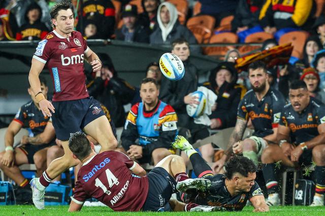Chiefs' Quinn Tupaea (R) is tackled during the Super Rugby Qualifying Final match between the Chiefs and Queensland Reds at FMG Stadium in Hamilton on June 6, 2026. (Photo by DJ MILLS / AFP)