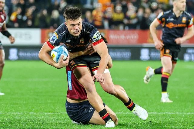 Chiefs' Kyren Taumoefolau is tackled during the Super Rugby Qualifying Final match between the Chiefs and Queensland Reds at FMG Stadium in Hamilton on June 6, 2026. (Photo by DJ MILLS / AFP)