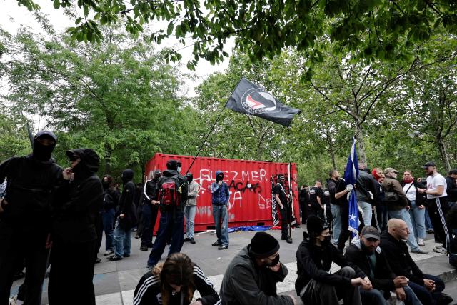 Demonstrators wave an "Antifascist action flag" (C) as they take part in a march to mark the 13th anniversary of the murder in 2013 of anti-fascist militant Clément Méric following a brawl with skinheads, in Paris on June 6, 2026. (Photo by STEPHANE DE SAKUTIN / AFP)