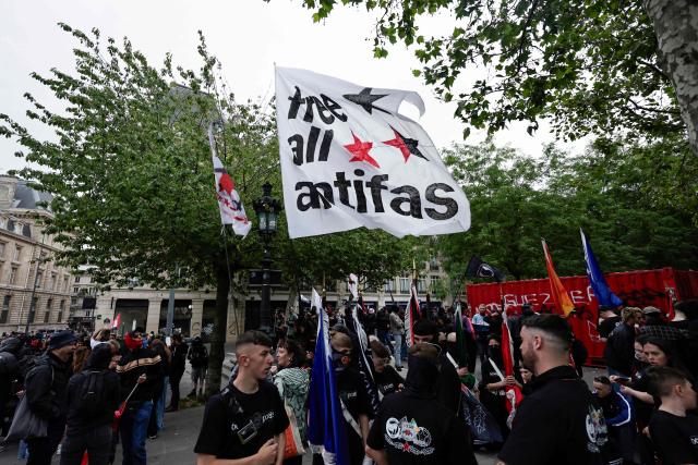 Demonstrators wave a flag reading "Free all antifas" as they take part in a march to mark the 13th anniversary of the murder in 2013 of anti-fascist militant Clément Méric following a brawl with skinheads, in Paris on June 6, 2026. (Photo by STEPHANE DE SAKUTIN / AFP)