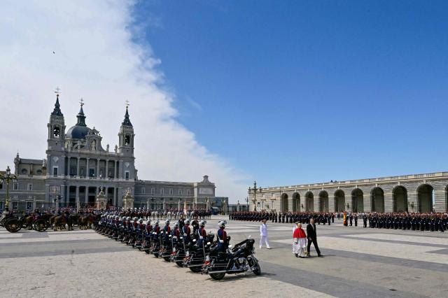 Spain's Felipe VI and Pope Leo XIV review the troops during a welcome ceremony at the Royal Palace in Madrid on June 6, 2026. Pope Leo XIV is visiting Spain June 6-12 with stops in Madrid, Barcelona, and the Canary Islands, where he will meet with migrants and organisations dedicated to helping them. (Photo by Stefano RELLANDINI / AFP)