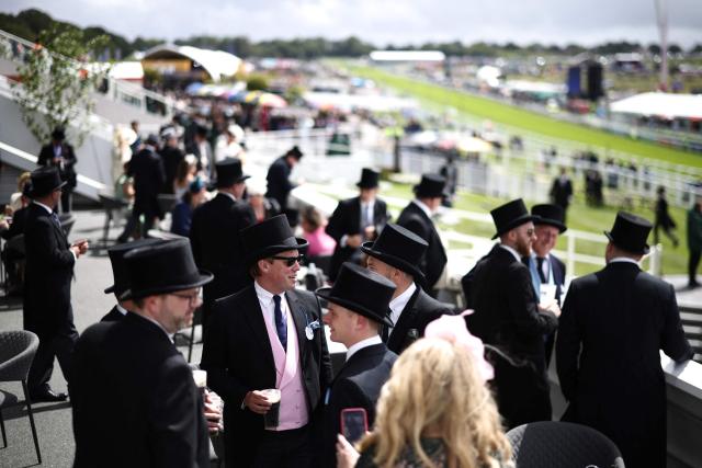 Racegoers enjoy a drink ahead of racing on the second day of the Epsom Derby Festival horse racing event in Surrey, southern England on June 6, 2026. (Photo by Henry NICHOLLS / AFP)