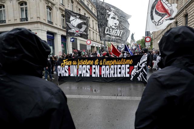 Demonstrators wave Paris-Banlieue Antifascist Action (AFAPB) flags and hold a banner reading "Faced with fascism and imperialism, not one step back" as they take part in a march to mark the 13th anniversary of the murder in 2013 of anti-fascist militant Clément Méric following a brawl with skinheads, in Paris on June 6, 2026. (Photo by STEPHANE DE SAKUTIN / AFP)