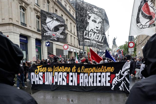 Demonstrators wave Paris-Banlieue Antifascist Action (AFAPB) flags and hold a banner reading "Faced with fascism and imperialism, not one step back" as they take part in a march to mark the 13th anniversary of the murder in 2013 of anti-fascist militant Clément Méric following a brawl with skinheads, in Paris on June 6, 2026. (Photo by STEPHANE DE SAKUTIN / AFP)