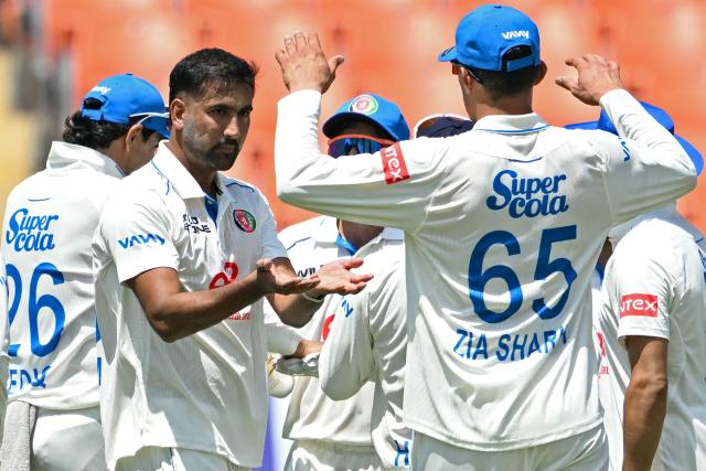 Afghanistan's Mohammad Saleem (2L) celebrates with teammates after taking the wicket of India's Sai Sudharsan during the first day of the only Test cricket match between India and Afghanistan at the Maharaja Yadavindra Singh International Cricket Stadium on the outskirts of Chandigarh on June 6, 2026. (Photo by Shammi MEHRA / AFP)