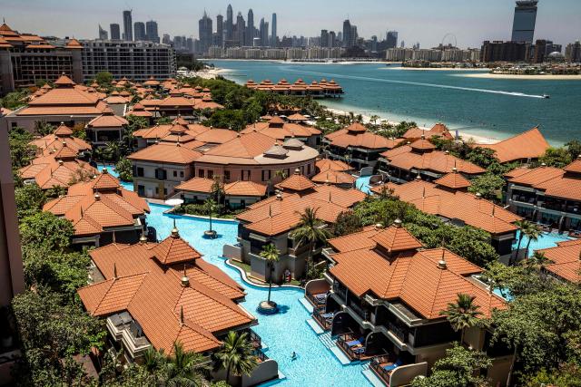 The Anantara The Palm Dubai Resort is pictured near the Dubai Marina (background) in Dubai on June 6, 2026. (Photo by FADEL SENNA / AFP)