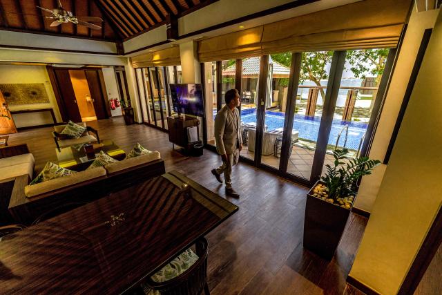 A man walks in a villa at the Anantara The Palm Dubai Resort in Dubai on June 6, 2026. (Photo by FADEL SENNA / AFP)