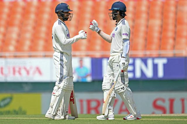 India's captain Shubman Gill (L) and KL Rahul bump their fists during the first day of the only Test cricket match between India and Afghanistan at the Maharaja Yadavindra Singh International Cricket Stadium on the outskirts of Chandigarh on June 6, 2026. (Photo by Shammi MEHRA / AFP)