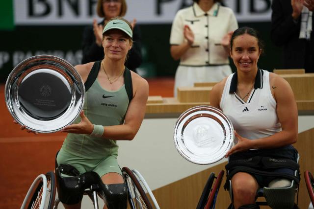 Winner Netherlands' Diede de Groot (L) and France's Ksenia Chasteau pose with their respective trophies after their women's singles wheelchair final match on day 14 of the French Open tennis tournament on Court Suzanne-Lenglen at the Roland-Garros Complex in Paris on June 6, 2026. (Photo by Dimitar DILKOFF / AFP)