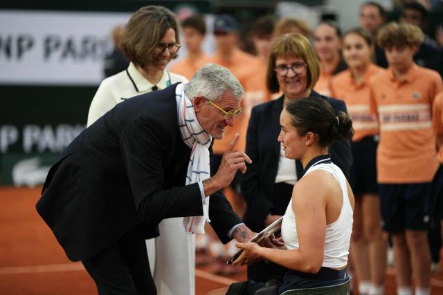 France's Ksenia Chasteau (R) receives her trophy from French Tennis Federation's President Gilles Moretton (L) after being defeating by Netherlands' Diede de Groot in their women's singles wheelchair final match on day 14 of the French Open tennis tournament on Court Suzanne-Lenglen at the Roland-Garros Complex in Paris on June 6, 2026. (Photo by Dimitar DILKOFF / AFP)