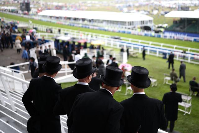 Racegoers mingle in the grandstand ahead of racing on the second day of the Epsom Derby Festival horse racing event in Surrey, southern England on June 6, 2026. (Photo by Henry NICHOLLS / AFP)