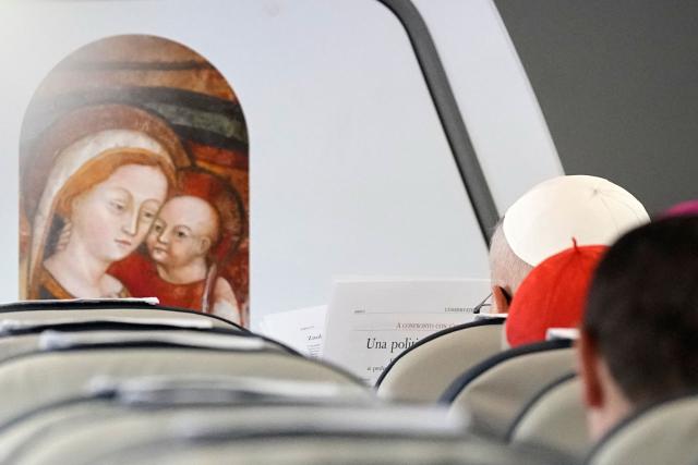 Pope Leo XIV reads aboard the papal flight heading to Madrid on June 6, 2026. Pope Leo XIV is visiting Spain June 6-12 with stops in Madrid, Barcelona, and the Canary Islands, where he will meet with migrants and organisations dedicated to helping them. (Photo by Alessandra Tarantino / POOL / AFP)