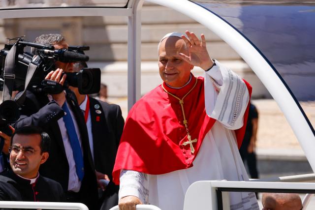 Pope Leo XIV waves to faithful gathered outside the Royal Palace in Madrid on June 6, 2026. Pope Leo XIV is visiting Spain June 6-12 with stops in Madrid, Barcelona, and the Canary Islands, where he will meet with migrants and organisations dedicated to helping them. (Photo by Oscar DEL POZO / AFP)