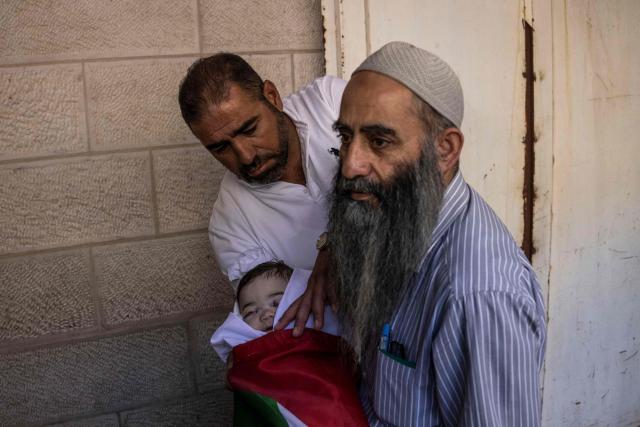 EDITORS NOTE: Graphic content / Family members carry the body of seven-month-old Sam Fahd Abou Haikal, at the Al-Ahli hospital in Hebron, in the occupied West Bank on June 6, 2026. The Palestinian health ministry said Israeli gunfire killed an infant and wounded his parents on June 5 in the occupied West Bank. Sam Fahd Abou Haikal, aged seven months, died and his parents were lightly injured "after the occupation forces opened fire on them on June 5 evening" in the south of the city of Hebron, the ministry said. (Photo by JOHN WESSELS / AFP)