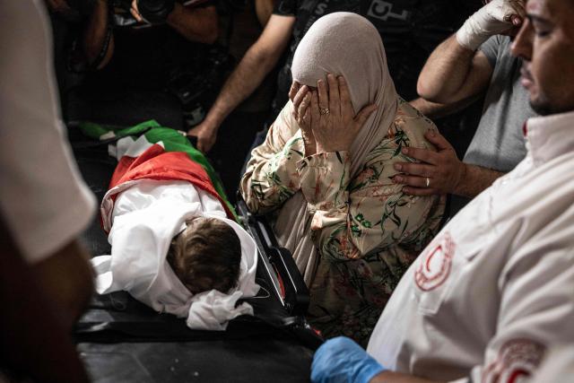 EDITORS NOTE: Graphic content / Firyal Abou Haikal, the grandmother of seven-month-old Sam Fahd Abou Haikal, weeps over his body at the Al-Ahli hospital in Hebron, in the occupied West Bank on June 6, 2026. The Palestinian health ministry said Israeli gunfire killed an infant and wounded his parents on June 5 in the occupied West Bank. Sam Fahd Abou Haikal, aged seven months, died and his parents were lightly injured "after the occupation forces opened fire on them on June 5 evening" in the south of the city of Hebron, the ministry said. (Photo by JOHN WESSELS / AFP)