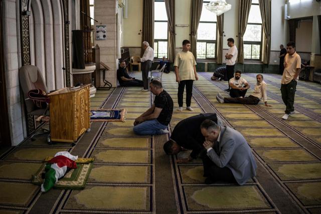EDITORS NOTE: Graphic content / Mourners offer prayers next to the body of seven-month-old Sam Fahd Abou Haikal, at the Abou Heisheh Mosque in Hebron, in the occupied West Bank on June 6, 2026. The Palestinian health ministry said Israeli gunfire killed an infant and wounded his parents on June 5 in the occupied West Bank. Sam Fahd Abou Haikal died and his parents were lightly injured "after the occupation forces opened fire on them on June 5 evening" in the south of the city of Hebron, the ministry said. (Photo by JOHN WESSELS / AFP)