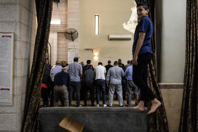 Mourners offer prayers near the body of seven-month-old Sam Fahd Abou Haikal (not pictured), at the Abou Heisheh Mosque in Hebron, in the occupied West Bank on June 6, 2026. The Palestinian health ministry said Israeli gunfire killed an infant and wounded his parents on June 5 in the occupied West Bank. Sam Fahd Abou Haikal died and his parents were lightly injured "after the occupation forces opened fire on them on June 5 evening" in the south of the city of Hebron, the ministry said. (Photo by JOHN WESSELS / AFP)