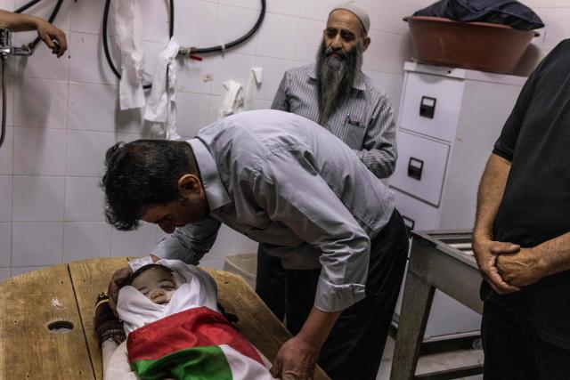 EDITORS NOTE: Graphic content / A family member weeps over the body of seven-month-old Sam Fahd Abou Haikal, at the Al-Ahli hospital in Hebron, in the occupied West Bank on June 6, 2026. The Palestinian health ministry said Israeli gunfire killed an infant and wounded his parents on June 5 in the occupied West Bank. Sam Fahd Abou Haikal, aged seven months, died and his parents were lightly injured "after the occupation forces opened fire on them on June 5 evening" in the south of the city of Hebron, the ministry said. (Photo by JOHN WESSELS / AFP)