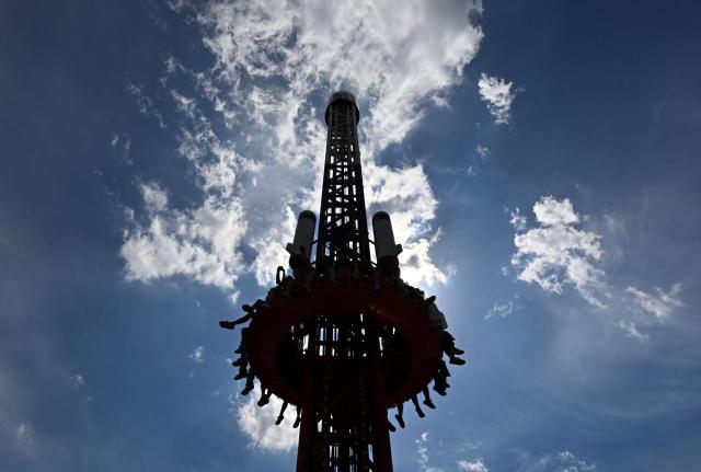 Visitors ride the "Oreshnik" attraction, named after Russia's nuclear-capable intermediate-range ballistic missile, at Divo Island amusement park in Saint Petersburg on June 6, 2026. (Photo by Olga MALTSEVA / AFP)