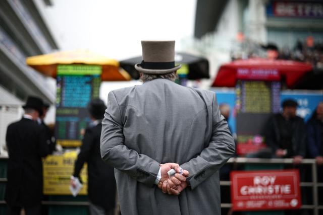 A punter eyes the bookmaker's board prices ahead of racing on the second day of the Epsom Derby Festival horse racing event in Surrey, southern England on June 6, 2026. (Photo by Henry Nicholls / AFP)