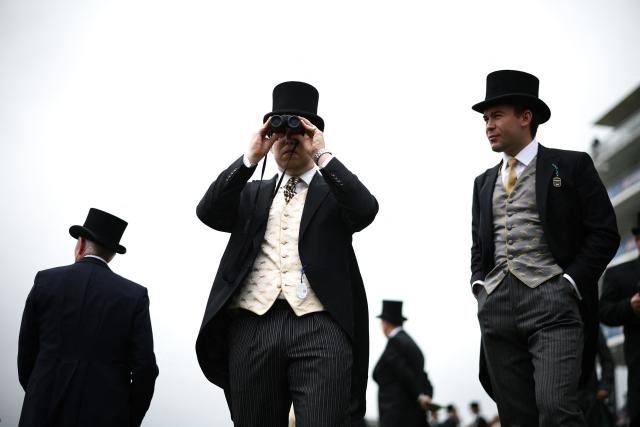 A racegoer uses a pair of binoculars ahead of racing on the second day of the Epsom Derby Festival horse racing event in Surrey, southern England on June 6, 2026. (Photo by Henry Nicholls / AFP)