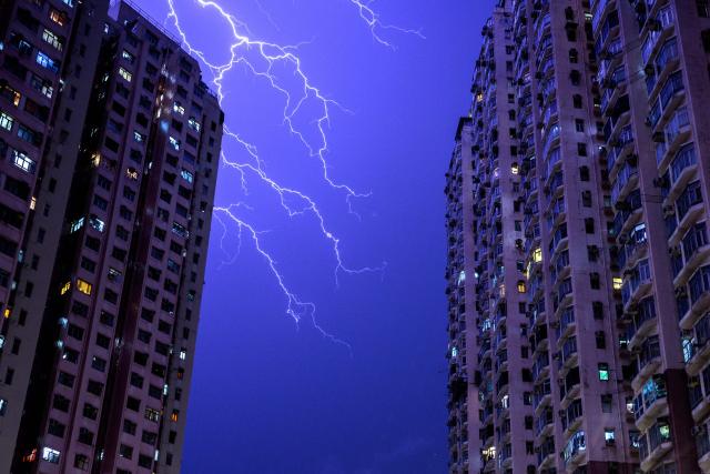 Lightning strikes illuminate the sky above a residential estate in the Tsuen Wan district of the New Territories in Hong Kong on June 6, 2026. (Photo by Philip FONG / AFP)