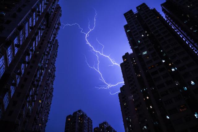 Lightning strikes illuminate the sky above a residential estate in the Tsuen Wan district of the New Territories in Hong Kong on June 6, 2026. (Photo by Philip FONG / AFP)