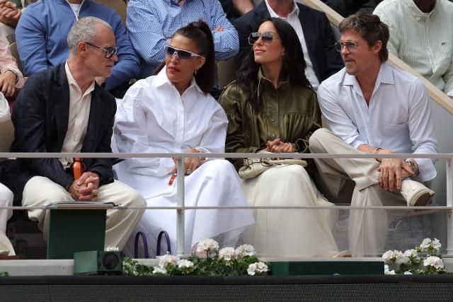 US actor Brad Pitt (R) sits with his partner US Ines de Ramon (2R), US musician Flea (L) and US fashion designer Melody Ehsani (2L) on Court Philippe-Chatrier ahead of the women's final singles match on day 14 of the French Open tennis tournament at the Roland-Garros Complex in Paris on June 6, 2026. (Photo by Thomas SAMSON / AFP)